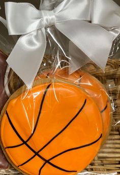 a cookie decorated like a basketball in a basket