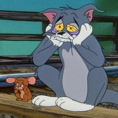 a cartoon cat sitting on top of a wooden bench next to a small brown teddy bear