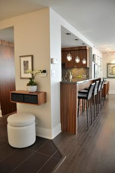 a kitchen and living room are separated by an open floor plan, while the dining area is adjacent to the kitchen