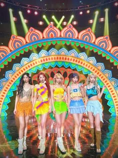 girls'generation performing on stage in front of colorful lights