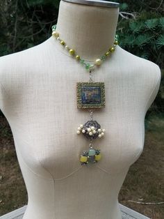 This is an assemblage of up-cycled vintage pins and pendants inspired by my Mom's jewelry box filled with pins, earrings, and strings of pearls from the '40s and '50s. It  features a beautiful green, yellow, cream, chain of faux pearls and crystal beads. Then a long pendant of two vintage pins and one pendant. Each pin-pendant has a lobster clasp so you can choose to wear one, two, or all three with the pearl chain necklace. The necklace is adjustable 16 to 18 inches. The pin-pendants are 6 inches long with all three attached as shown. There is a pair of matching earrings that are listed separately on my shop shown in a few of the pictures that are not a part of this sale. Vintage Upcycled Jewelry As Gift, Unique Upcycled Jewelry As A Gift, Unique Upcycled Jewelry Gift, Unique Upcycled Jewelry For Gifts, Upcycling Jewelry, Artsy Clothes, Vintage Assemblage Necklace, Old Jewelry Crafts, Pins Earrings