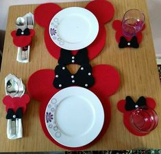 the table is set with mickey mouse plates and silverware