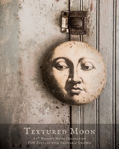 a close up of a door with a clock on it's face and the words textured moon above it