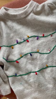 a white sweater with christmas lights on it