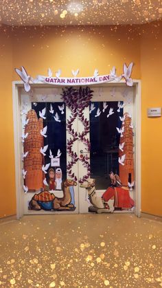 an open door decorated with paper cutouts and white doves in the center, surrounded by gold flakes