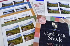 several cardstock stacked on top of each other next to papers with pictures and text