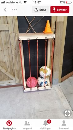 a shelf with some balls in it and an orange cone on top of the shelf