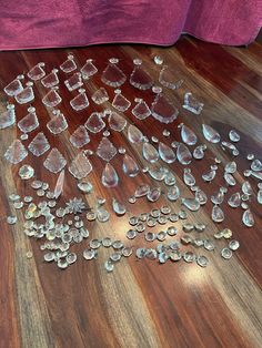 several pieces of glass sitting on the floor next to a pink couch and purple chair