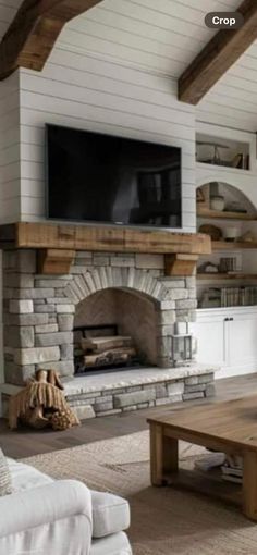 a living room filled with furniture and a flat screen tv mounted on the wall above a fireplace