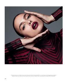 a woman with her hands on her head and red lipstick in front of her face