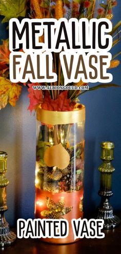 a vase filled with lots of different types of fall leaves and gold coins on top of a wooden table