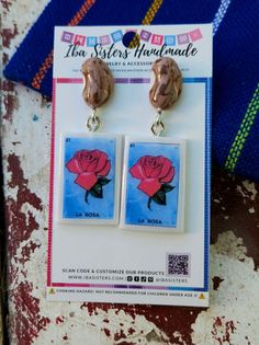 Beans with loteria card la rosa earrings made by Iba Sisters. Frijoles con carta de loteria la rosa aretes hechos por Iba Sisters Game Earrings, Silica Packets, Mexican Earrings, Handmade Earring, Inspired Jewelry, Uv Resin, Fabric Bag, Jewelry Case, Sterling Silver Studs