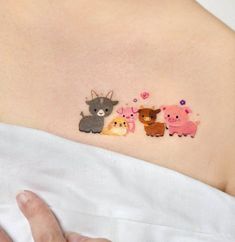 a woman's stomach with three small embroidered animals on the side of her belly