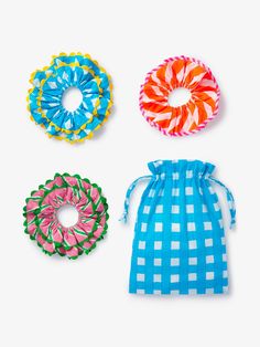 Add a playful touch to your hairstyles with the Resort Scrunchie Set. Made using leftover fabrics from the resort dresses, this colorful trio is as sustainable as it is stylish. The set includes two scrunchies with a charming ric rac trim and one featuring neon stripe piping for a unique, vibrant finish. Perfect for brightening up any look, these super cute scrunchies are a fun and versatile addition to your wardrobe. Presented in a matching screen-printed drawstring bag, this set makes a thoughtful gift or a delightful treat for yourself. Organic cotton Mix of block-printed and screen-printed fabric 3 scrunchies and one drawstring bag in set Machine wash on a gentle cycle at 30 degrees or less. Made in India Cute Scrunchies, Beulah London, Neon Stripes, Pink City, Screen Printed Fabric, Resort Dresses, Leftover Fabric, Ric Rac, Printed Drawstring