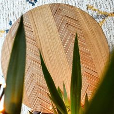 a wooden plate sitting on top of a table next to plants