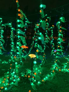 green and orange lights in the shape of leaves on display at an outdoor garden show