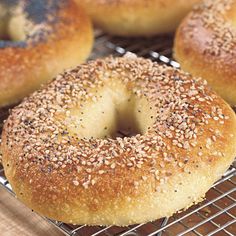 sesame seed bagels cooling on a wire rack