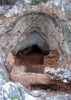 the entrance to an underground cave with steps leading into it