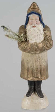 a statue of santa holding a plant in his hand