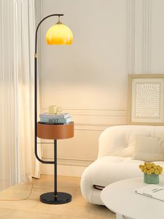 a living room with a white couch and a yellow lamp on the table next to it