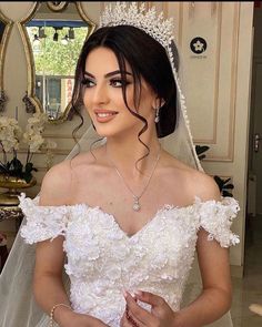 a woman wearing a wedding dress and tiara