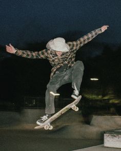 a man flying through the air while riding a skateboard