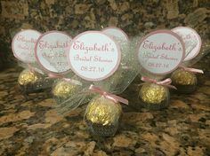 four herspooos wrapped in pink and gold foil on top of a granite counter