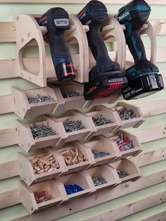 a wall mounted tool rack filled with drill and screwdriver attachments next to other tools