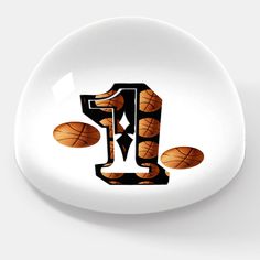 the letter j is made up of basketballs on a white plate with black lettering