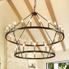 a large chandelier hanging from the ceiling in a room with exposed wood beams