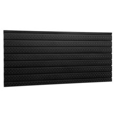 a black wall panel with diamond patterning on the bottom and sides, in front of a