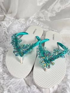 White bridal flip flops are wrapped with teal green satin ribbon and teal blue lace with iridescent sequins.  Ribbon color is teal green if you are needing other colors of ribbon or decoration please contact me and will be happy to accommodate you! All flip flops are handmade to order and the production time is 5-7 business days and then please allow additional time for shipping.   Amazing for beach, weddings, flower girl or a fancy event, you choose! Please choose your size from the drop box. P Flip Flops Wedding, Bridal Flip Flops, Beach Wedding Sandals, Wedding Flip Flops, Flip Flops Beach, Fancy Event, White Flip Flops, Bridal Sandals, Drop Box