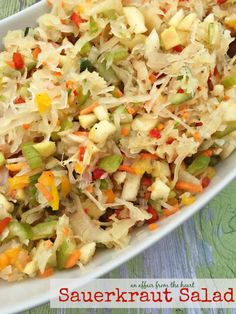 sauerkraut salad with carrots and celery in a white serving dish