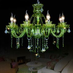 green jade chandelier hanging from the ceiling in front of a cityscape