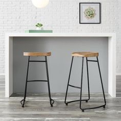 two stools sitting in front of a white counter