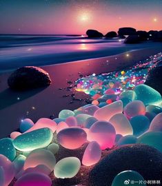 the beach is filled with glowing rocks and pebbles