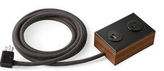 a black and brown cord connected to a wooden box with two plugs on it