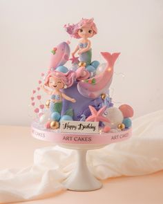 there is a cake that has mermaids on it