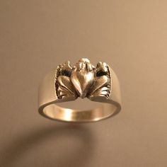 "You must like frogs, or you wouldn't be looking! This is a very well made sterling silver froglet! I first carved this piece in wax, then cast it in the lost wax process. It actually reminds me in some way of Pre Columbian art. The ring shown has a brush finish, but it can also be done in high polish. The top of the ring measures just under 3/8\" wide x 1/2\" across. Just the right size for a handsome frog! (really!) Thanks for looking! RIBBBITT !!" Princes Ring, Columbian Art, Frog Ring, Frog Jewelry, Metalwork Jewelry, Frog Prince, Casting Jewelry, Lost Wax, Ring Sterling Silver