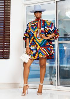 A woman posing in a multicolored African print mini dress. Ankara Short Set For Women, African Magic, Short Ankara Dresses, Next In Fashion, African Vibes, Nigerian Outfits, Ankara Outfits, Ghana Fashion, Shweshwe Dresses