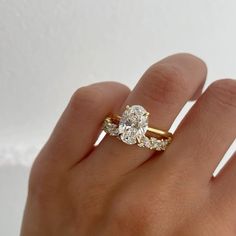 a woman's hand with a ring on it and a diamond in the middle