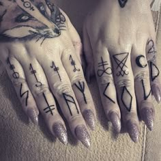 two hands with different tattoos on them