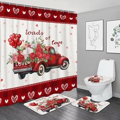 a red truck with roses and hearts on it is sitting in front of a white toilet