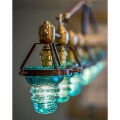 a row of glass vases hanging from the ceiling