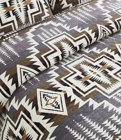 the comforter is made up with brown and white geometric designs on it's sides