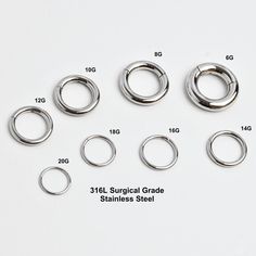 various sizes and shapes of metal rings on a white background with measurements for each ring