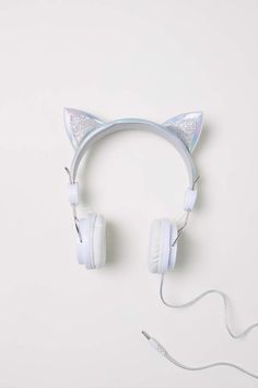 a pair of white headphones with silver cat ears on top of each earpiece