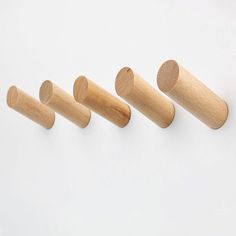 four wooden pegs lined up in a row