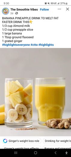 a glass filled with bananas and other fruits next to a cup of juice on top of a table