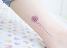 a small pink rose tattoo on the ankle